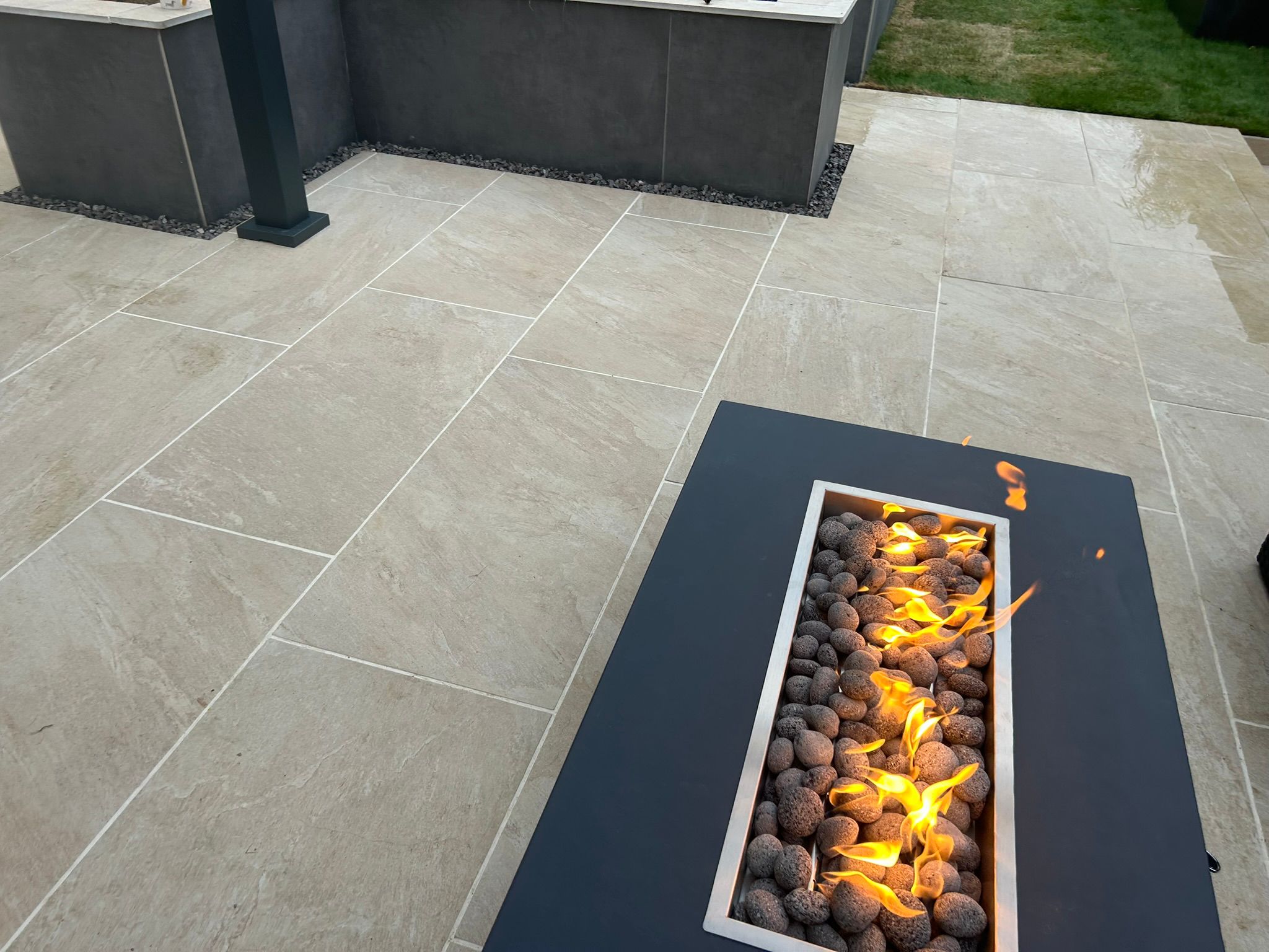 Overhead close-up of flames and a lava stone bed inside a rectangular fire table